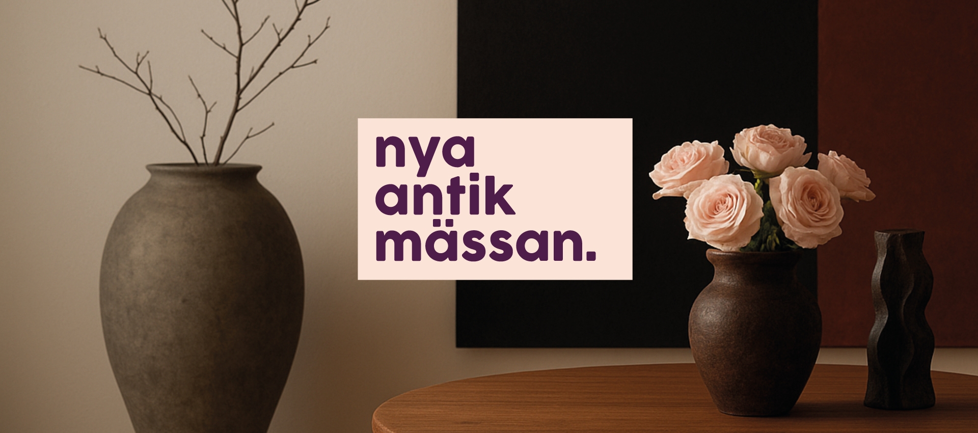 A poster with the text "nya antik mässan." in purple letters on a light background. In the background, there is a vase with branches and another vase with roses.