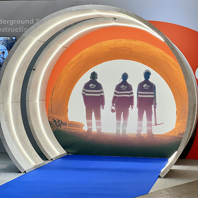 world-tunnel-congress-booth-stockholm-fair-640x640px Exhibition portal with image of three tunnel workers illuminated from behind, standing in a tunnel.