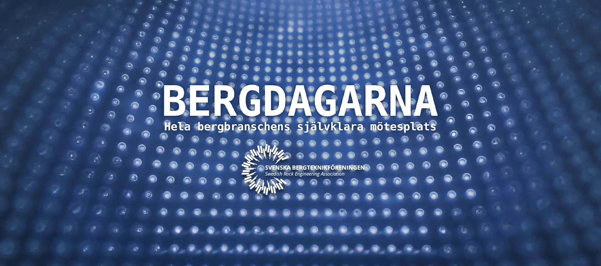 Bergdagarna 4 A blue background with a pattern of glowing dots, featuring the text “Bergdagarna – The natural meeting place for the entire rock engineering industry” and the Swedish Rock Engineering Association’s logo in the centre.