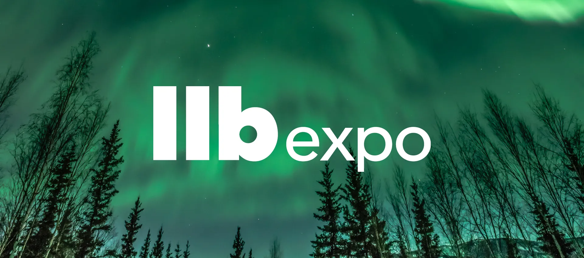 Image showing green northern lights across the night sky above dark tree silhouettes, with the Ilbexpo logo in white in the foreground.